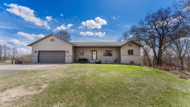 ranch-style home with a front lawn, concrete driveway, brick siding, and an attached garage