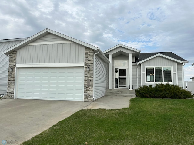 6054 59th St S, Fargo, ND 58104 - single story home featuring a front lawn, stone siding, a garage, board and batten siding, and concrete driveway