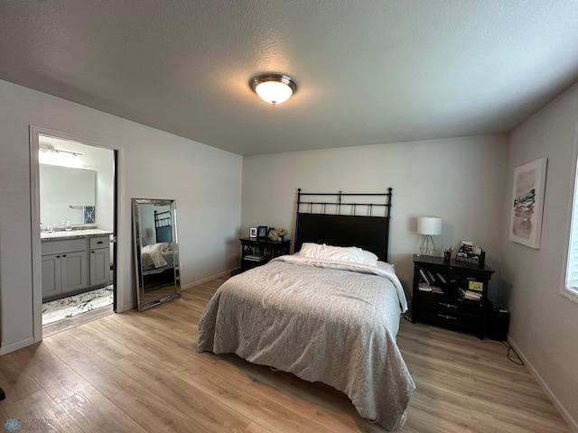 6054 59th St S, Fargo, ND 58104 - bedroom featuring baseboards, light wood finished floors, and ensuite bath