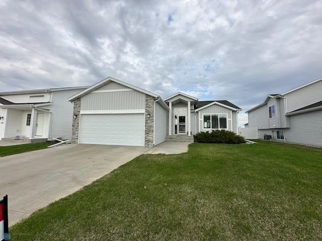 6054 59th St S, Fargo, ND 58104 - ranch-style house with an attached garage, a front lawn, stone siding, board and batten siding, and driveway