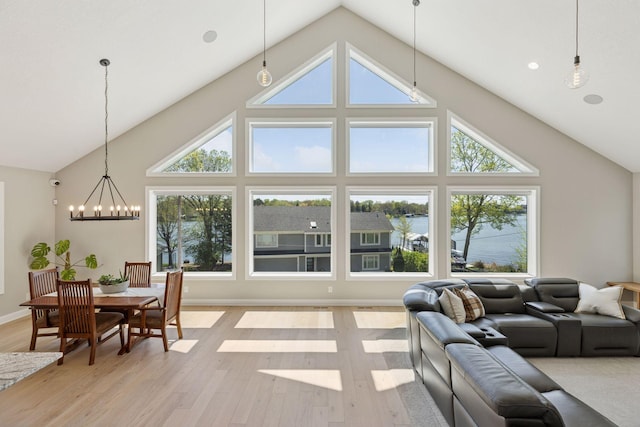 1929 Fagerness Point Rd, Orono, MN 55391 - living room with high vaulted ceiling, a chandelier, and light wood-style flooring