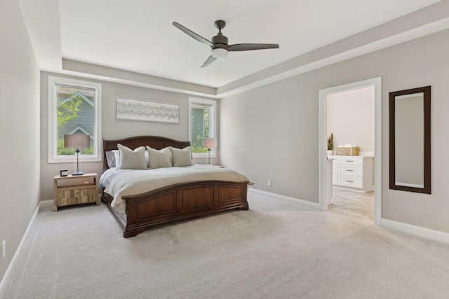 1929 Fagerness Point Rd, Orono, MN 55391 - bedroom with light colored carpet, a tray ceiling, baseboards, and a ceiling fan