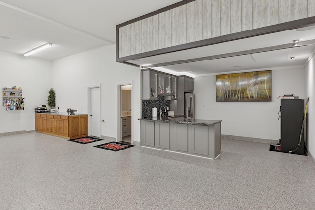 1929 Fagerness Point Rd, Orono, MN 55391 - kitchen featuring speckled floor, glass insert cabinets, stainless steel fridge with ice dispenser, gray cabinets, and decorative backsplash