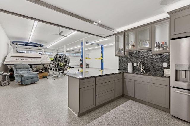 1929 Fagerness Point Rd, Orono, MN 55391 - kitchen featuring stainless steel fridge, gray cabinetry, a peninsula, and dark stone counters