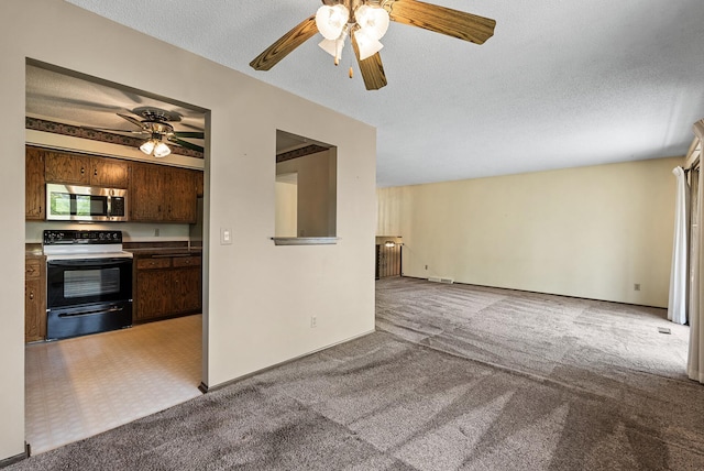 unfurnished living room featuring a ceiling fan, a textured ceiling, visible vents, and light colored carpet