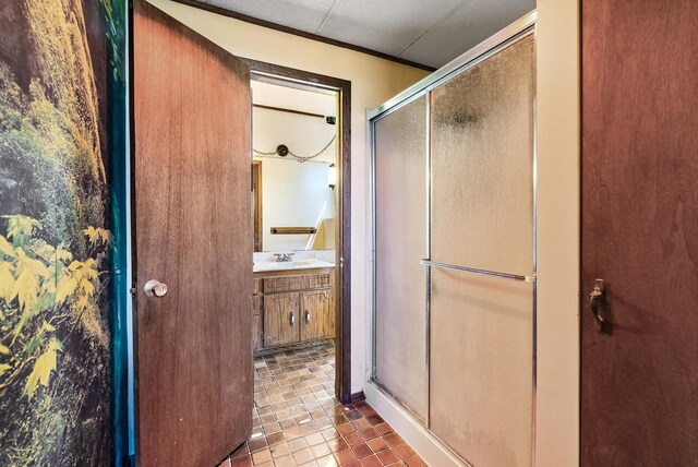 full bathroom with a stall shower, tile patterned flooring, and vanity
