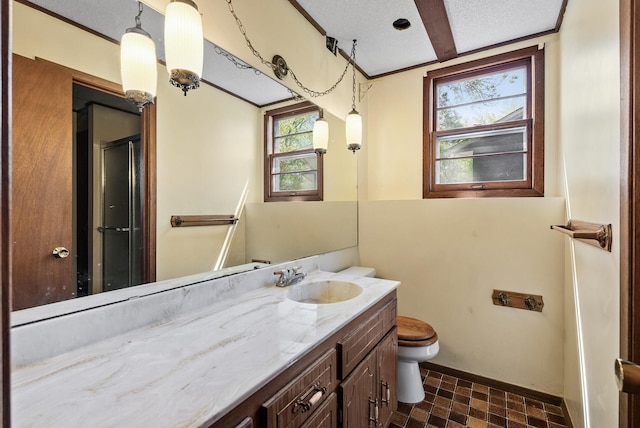 full bathroom featuring a shower with shower door, vanity, toilet, and baseboards