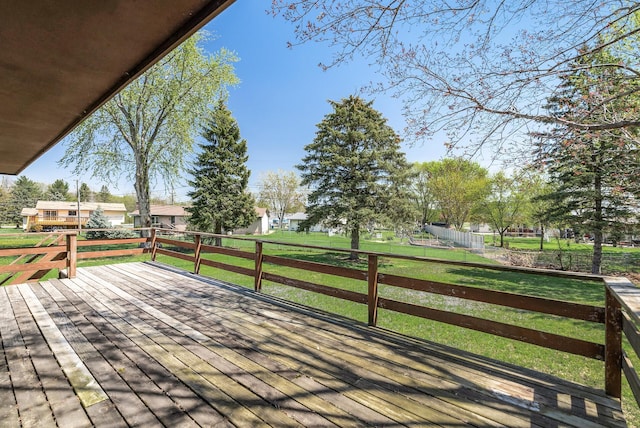 deck with a yard and fence