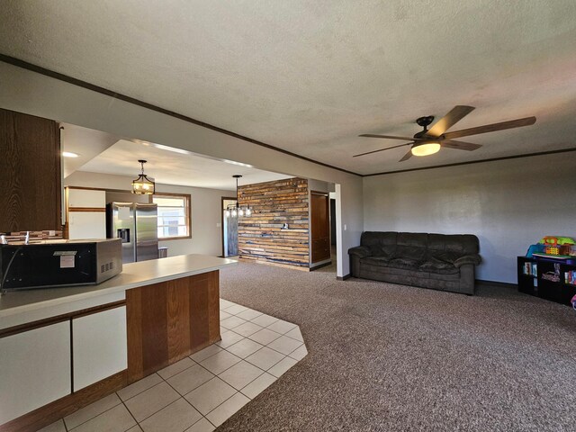 12405 State Highway 91, Leota Twp, MN 56155 - kitchen with stainless steel fridge with ice dispenser, black microwave, a textured ceiling, light carpet, and a peninsula