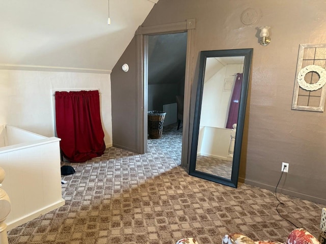 bathroom featuring vaulted ceiling and baseboards