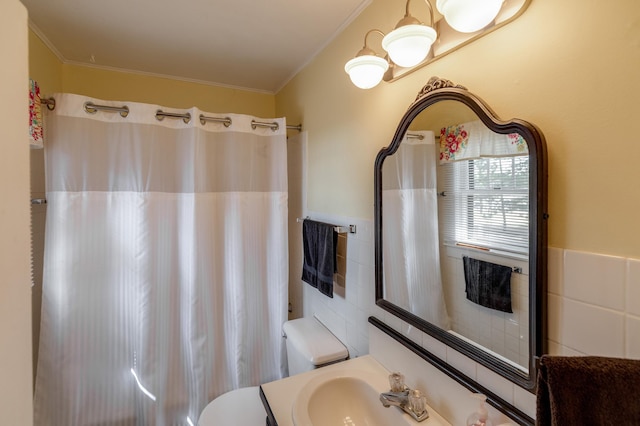 bathroom featuring tile walls, crown molding, toilet, a shower with curtain, and vanity