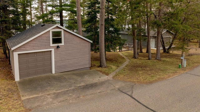 detached garage featuring driveway