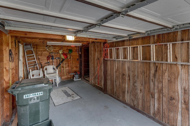 garage featuring wood walls