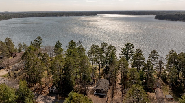 aerial view of property and surrounding area featuring a nearby body of water