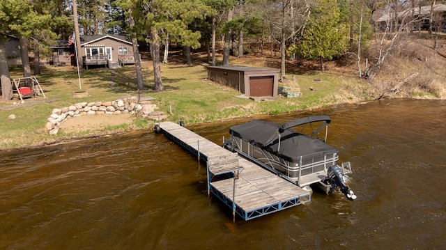 dock area with a water view and a yard