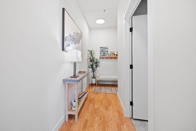 hallway with baseboards and light wood-type flooring