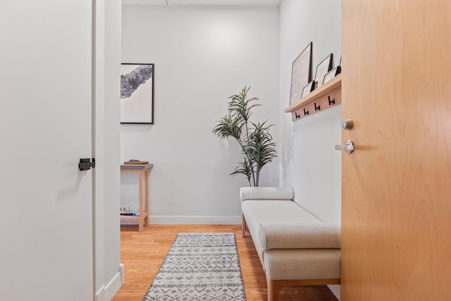 sitting room featuring baseboards and light wood-style floors