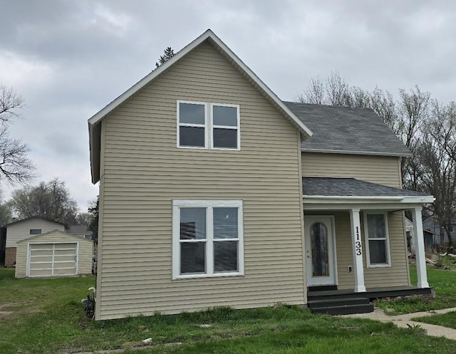 traditional-style home with a porch, an outbuilding, a storage shed, roof with shingles, and a front lawn