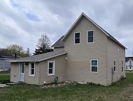back of property featuring a yard