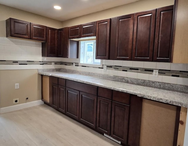 kitchen with recessed lighting, decorative backsplash, dark brown cabinets, baseboards, and light wood-type flooring