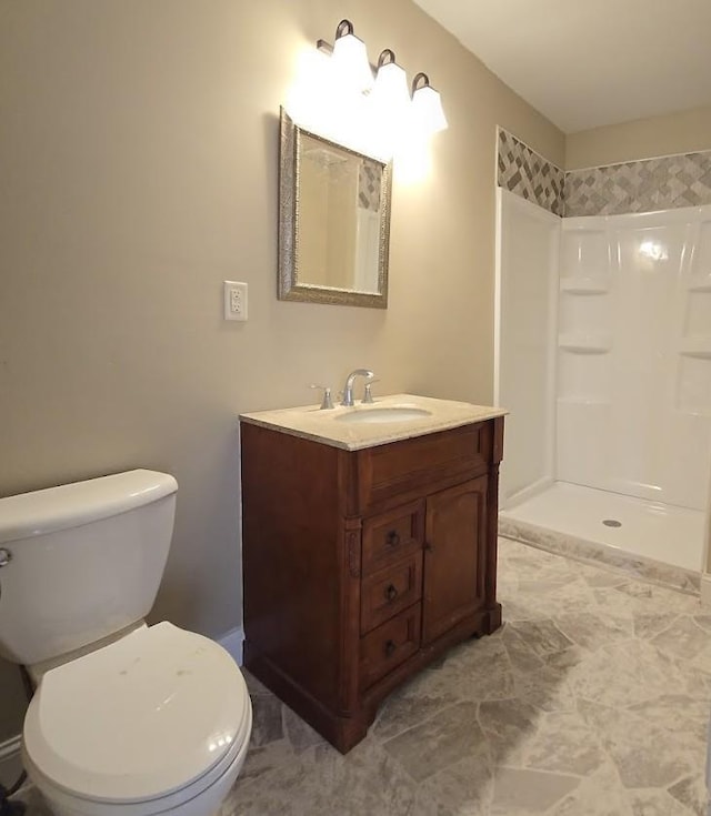 bathroom with walk in shower, toilet, and vanity