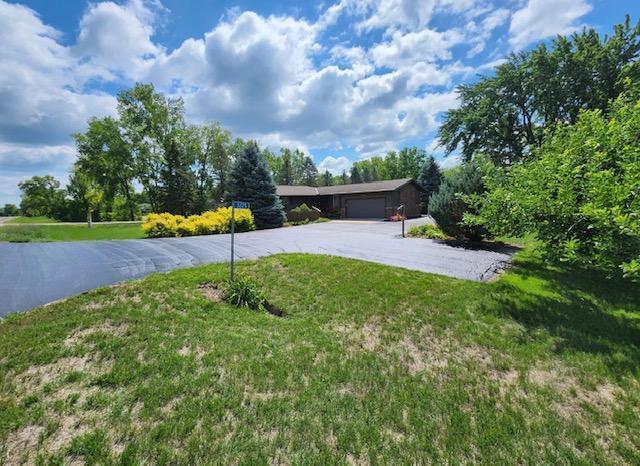 3225 180th St, Lester Prairie, MN 55354 - view of front of home featuring an attached garage, a front yard, and aphalt driveway