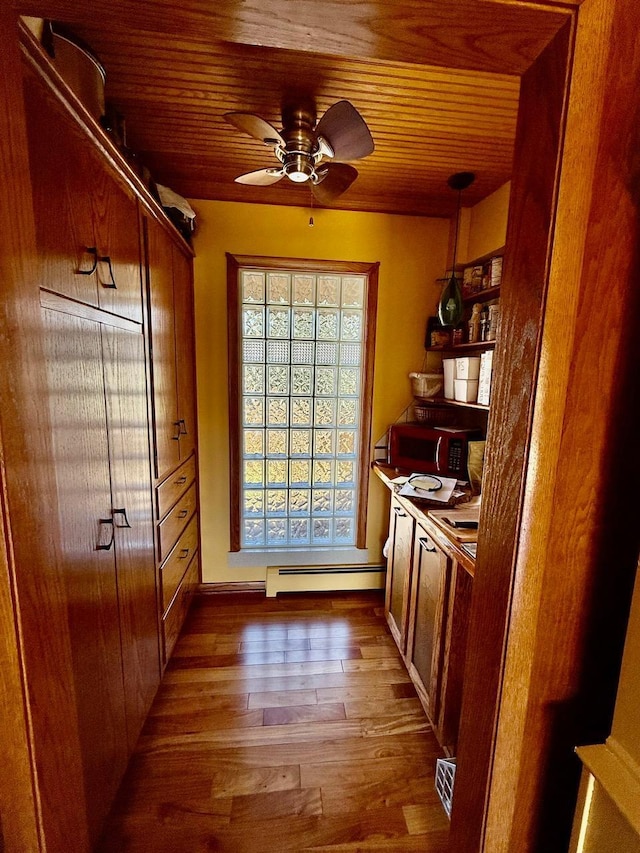 3225 180th St, Lester Prairie, MN 55354 - doorway with wood ceiling, a ceiling fan, a baseboard heating unit, and wood finished floors