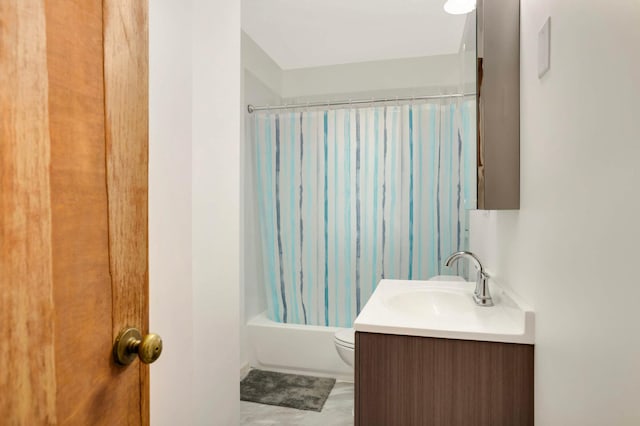 bathroom with vanity, shower / tub combo, and toilet