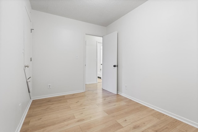 6715 Bloomington Ave, Richfield, MN 55423 - spare room with light wood-style floors, baseboards, and a textured ceiling