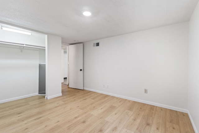 6715 Bloomington Ave, Richfield, MN 55423 - unfurnished bedroom featuring visible vents, baseboards, wood finished floors, and a closet