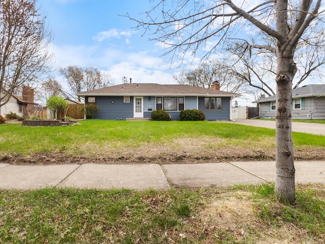 6715 Bloomington Ave, Richfield, MN 55423 - ranch-style home with fence, a chimney, and a front lawn