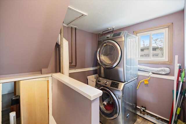 laundry room with stacked washing maching and dryer and laundry area