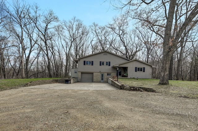 view of front of property with a garage and concrete driveway