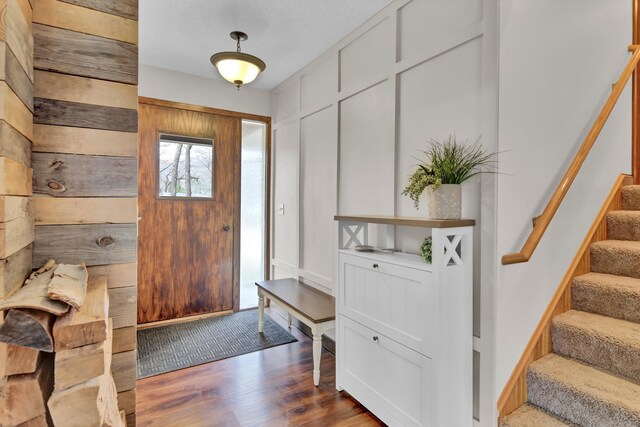 entrance foyer with wood finished floors and stairway