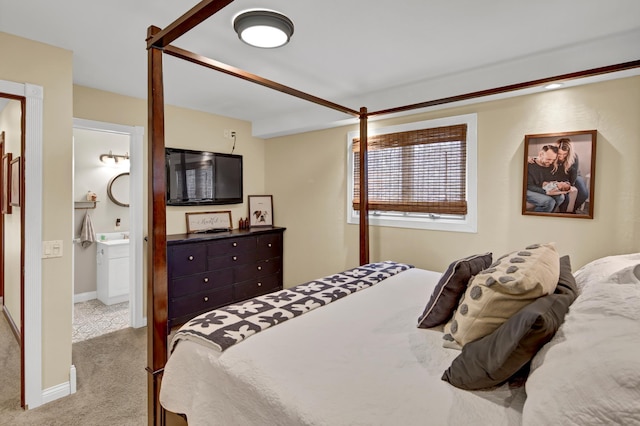 bedroom featuring baseboards, carpet flooring, and ensuite bath