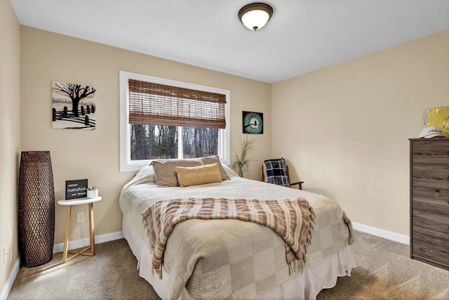 carpeted bedroom featuring baseboards