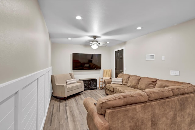 living room featuring ceiling fan, recessed lighting, light wood-style flooring, and visible vents