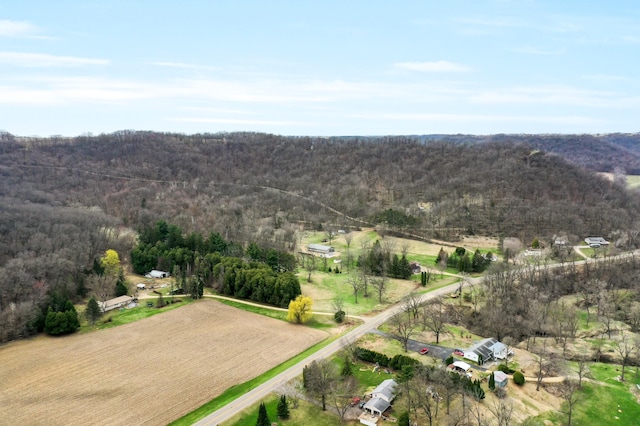 aerial view featuring a rural view and a wooded view
