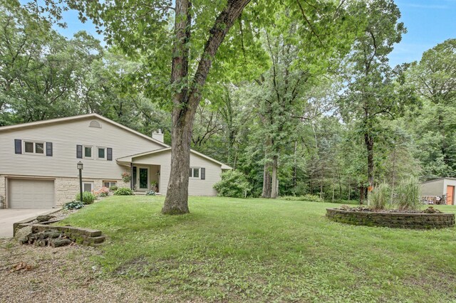 73466 318th Ave, Lake City, MN 55041 - view of grassy yard featuring a garage and concrete driveway