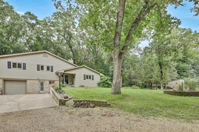 73466 318th Ave, Lake City, MN 55041 - view of front of home with driveway, stone siding, a front lawn, and an attached garage