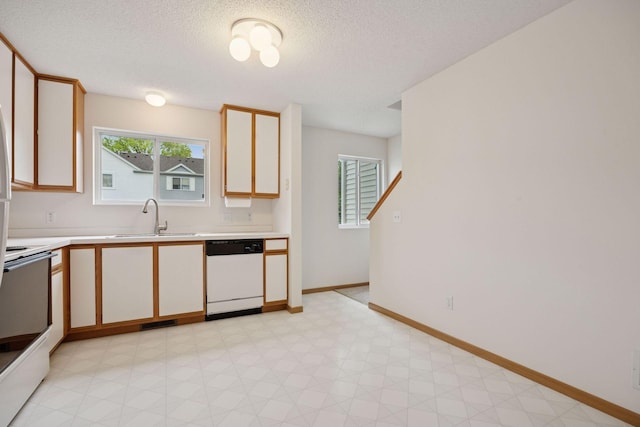 9110 Terra Verde Trl, Eden Prairie, MN 55347 - kitchen featuring white dishwasher, a sink, range, light countertops, and light floors