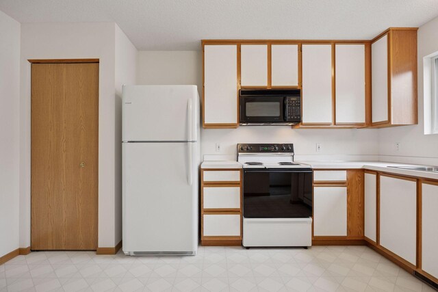 9110 Terra Verde Trl, Eden Prairie, MN 55347 - kitchen with freestanding refrigerator, black microwave, electric range, light countertops, and light floors