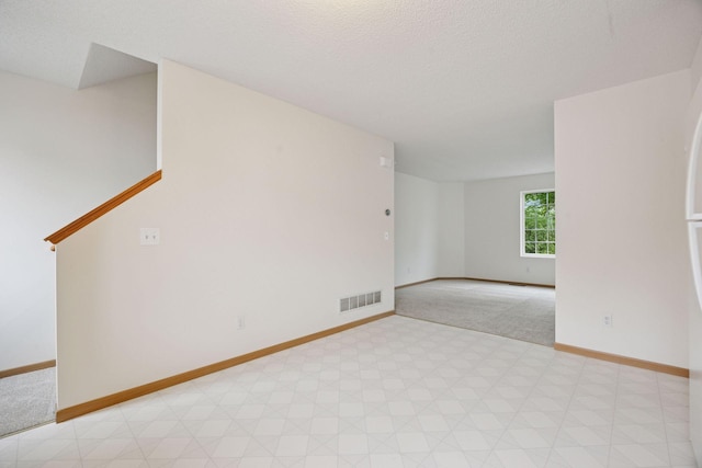 9110 Terra Verde Trl, Eden Prairie, MN 55347 - spare room with baseboards, light carpet, and a textured ceiling