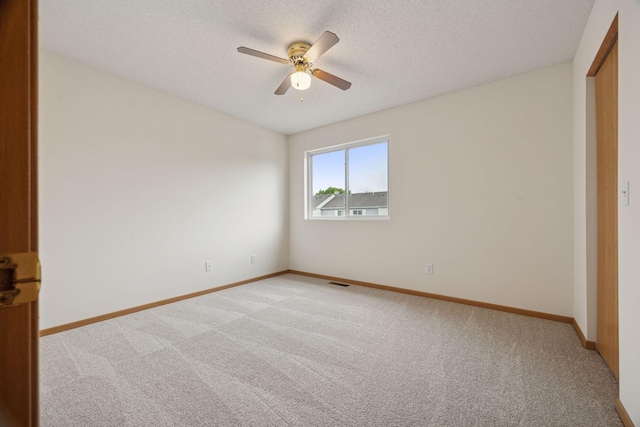9110 Terra Verde Trl, Eden Prairie, MN 55347 - unfurnished bedroom featuring light colored carpet, baseboards, a textured ceiling, a ceiling fan, and a closet