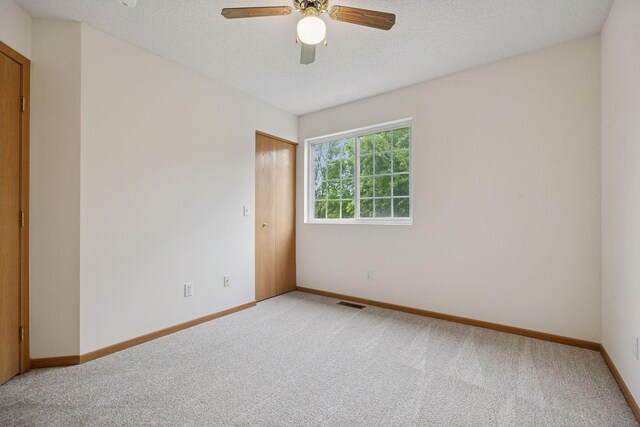 9110 Terra Verde Trl, Eden Prairie, MN 55347 - unfurnished room with light colored carpet, baseboards, ceiling fan, and a textured ceiling