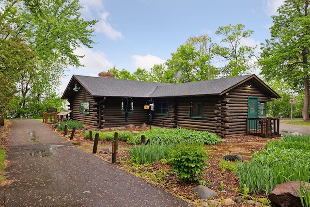 9110 Terra Verde Trl, Eden Prairie, MN 55347 - view of front of property featuring log siding, a chimney, and driveway
