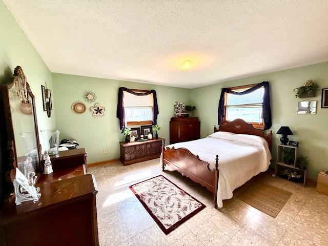 15497 Meiners Rd, Mayville Twp, MN 55921 - bedroom featuring a textured ceiling and light flooring