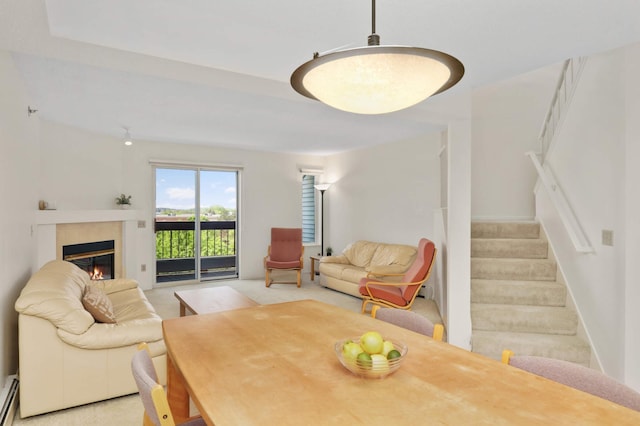 7540 Edinborough Way Unit 1319, Edina, MN 55435 - dining area featuring stairs, a baseboard radiator, light colored carpet, and a glass covered fireplace