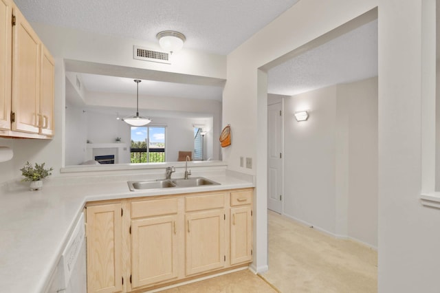 7540 Edinborough Way Unit 1319, Edina, MN 55435 - kitchen featuring a sink, light brown cabinets, light countertops, light colored carpet, and a textured ceiling