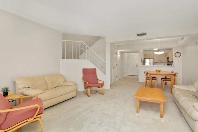 7540 Edinborough Way Unit 1319, Edina, MN 55435 - living area featuring stairs, light colored carpet, and a baseboard heating unit